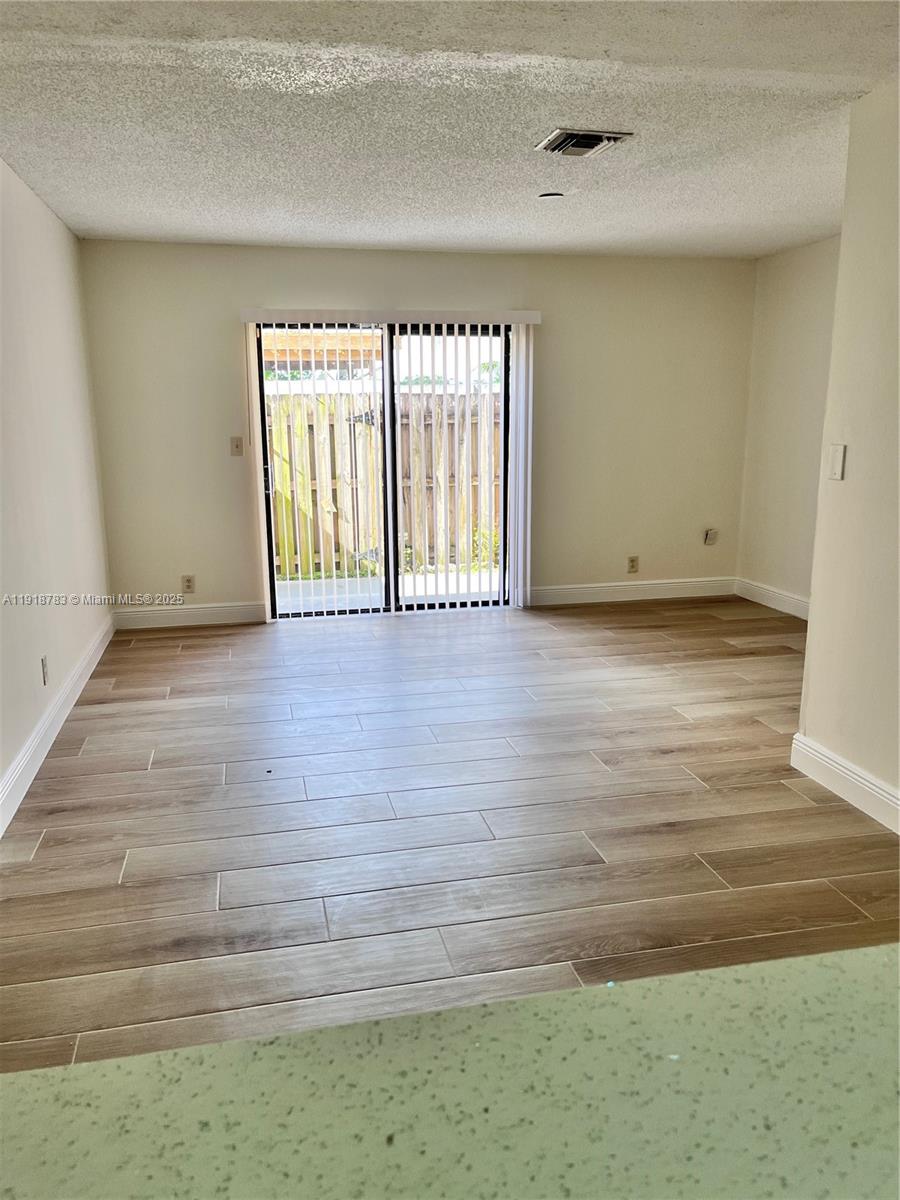 3281 East Golf Boulevard, Unit 12 Pompano Beach, FL 33064 - Photo 6 of 21 a view of an empty room with a window