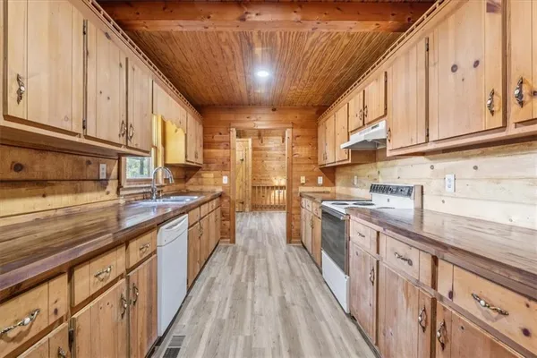 a kitchen with stainless steel appliances granite countertop a sink and cabinets