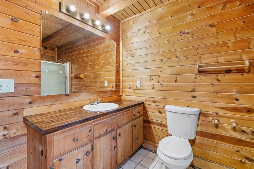 910 Brushtown Road Cisco, GA 30708 - Photo 23 of 30 a bathroom with a granite countertop toilet sink and mirror