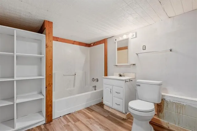 a bathroom with a toilet a sink and bathtub