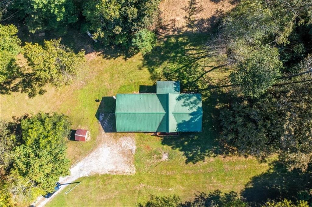 910 Brushtown Road Cisco, GA 30708 - Photo 5 of 30 a green field with trees in the background