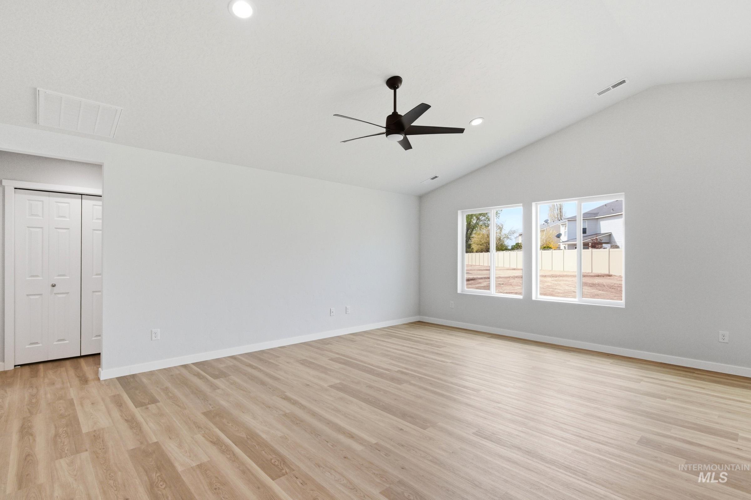 13735 Inman Court Caldwell, ID 83607 - Photo 9 of 20 Empty room with ceiling fan, lofted ceiling, light wood-style flooring, and recessed lighting