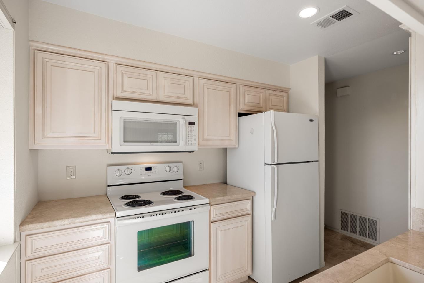 121 Quail Run Court Del Rey Oaks, CA 93940 - Photo 11 of 33 a kitchen with a stove top oven and refrigerator