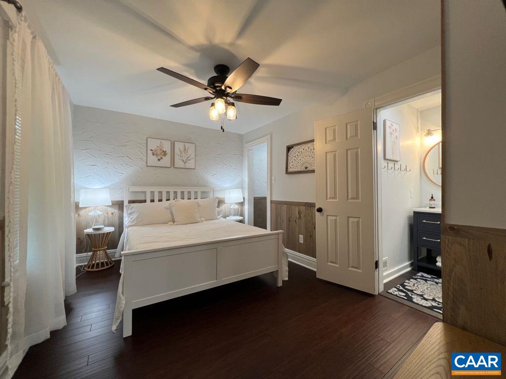 161 Avon Road Afton, VA 22920 - Photo 17 of 39 a spacious bedroom with a bed and a chandelier