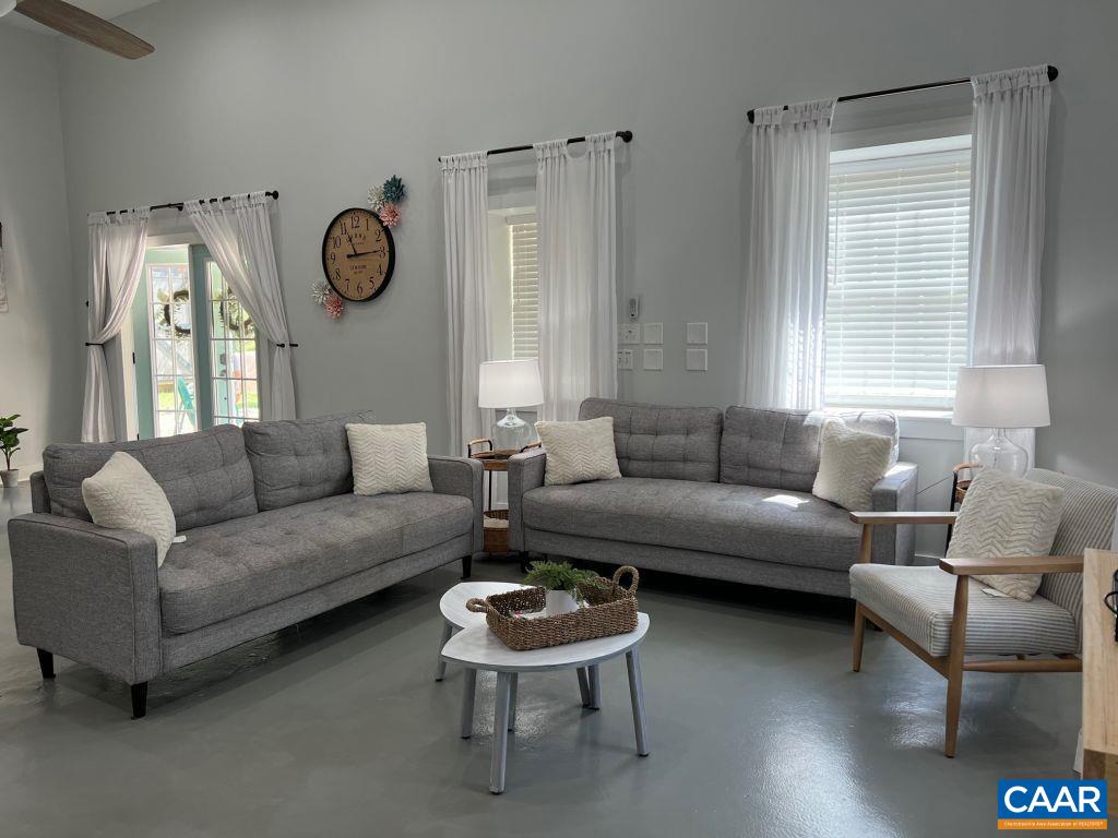 161 Avon Road Afton, VA 22920 - Photo 31 of 39 a living room with furniture a large window and a clock
