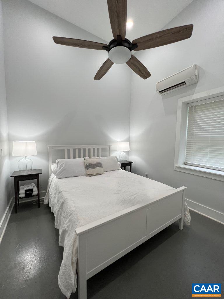 161 Avon Road Afton, VA 22920 - Photo 35 of 39 a bedroom with a bed and a chandelier