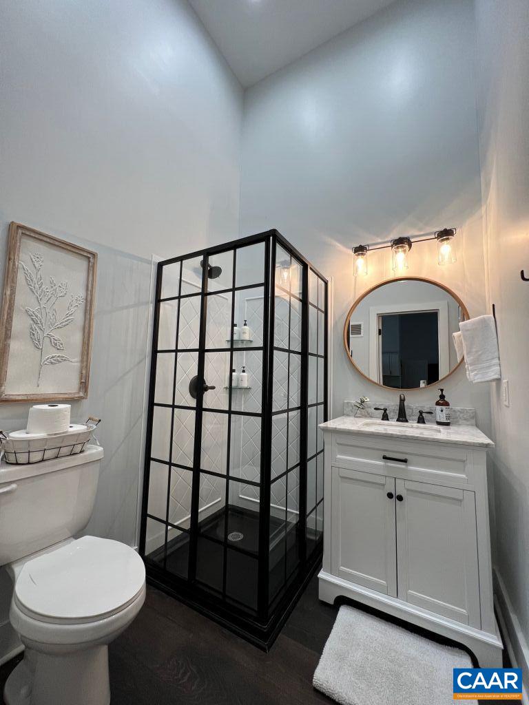 161 Avon Road Afton, VA 22920 - Photo 38 of 39 a bathroom with a toilet sink vanity granite and a mirror
