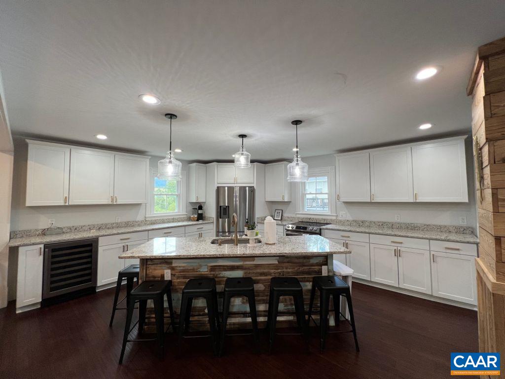 161 Avon Road Afton, VA 22920 - Photo 4 of 39 a kitchen with kitchen island granite countertop a table chairs sink and cabinets