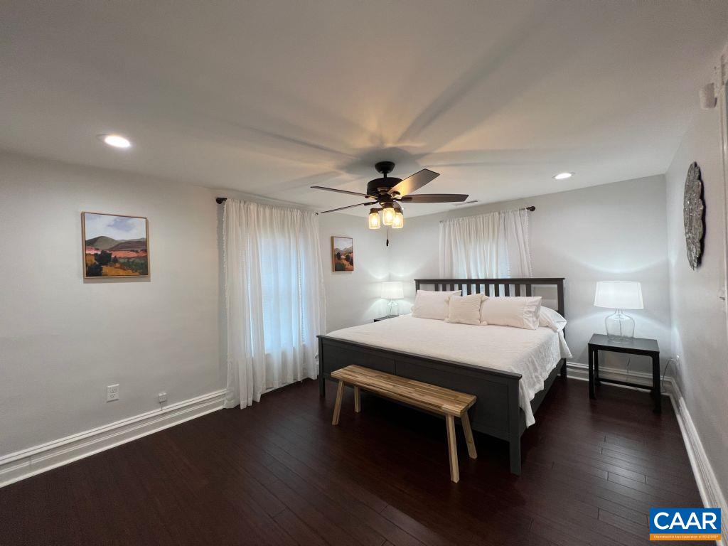 161 Avon Road Afton, VA 22920 - Photo 8 of 39 a spacious bedroom with a bed and a chandelier