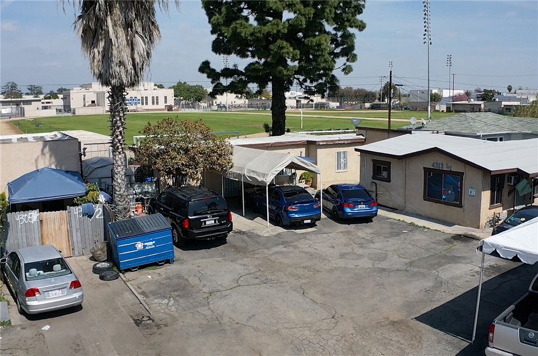 4313 Florence Avenue Bell, CA 90201 - Photo 5 of 5 a view of a patio with table and chairs potted plants and a large tree