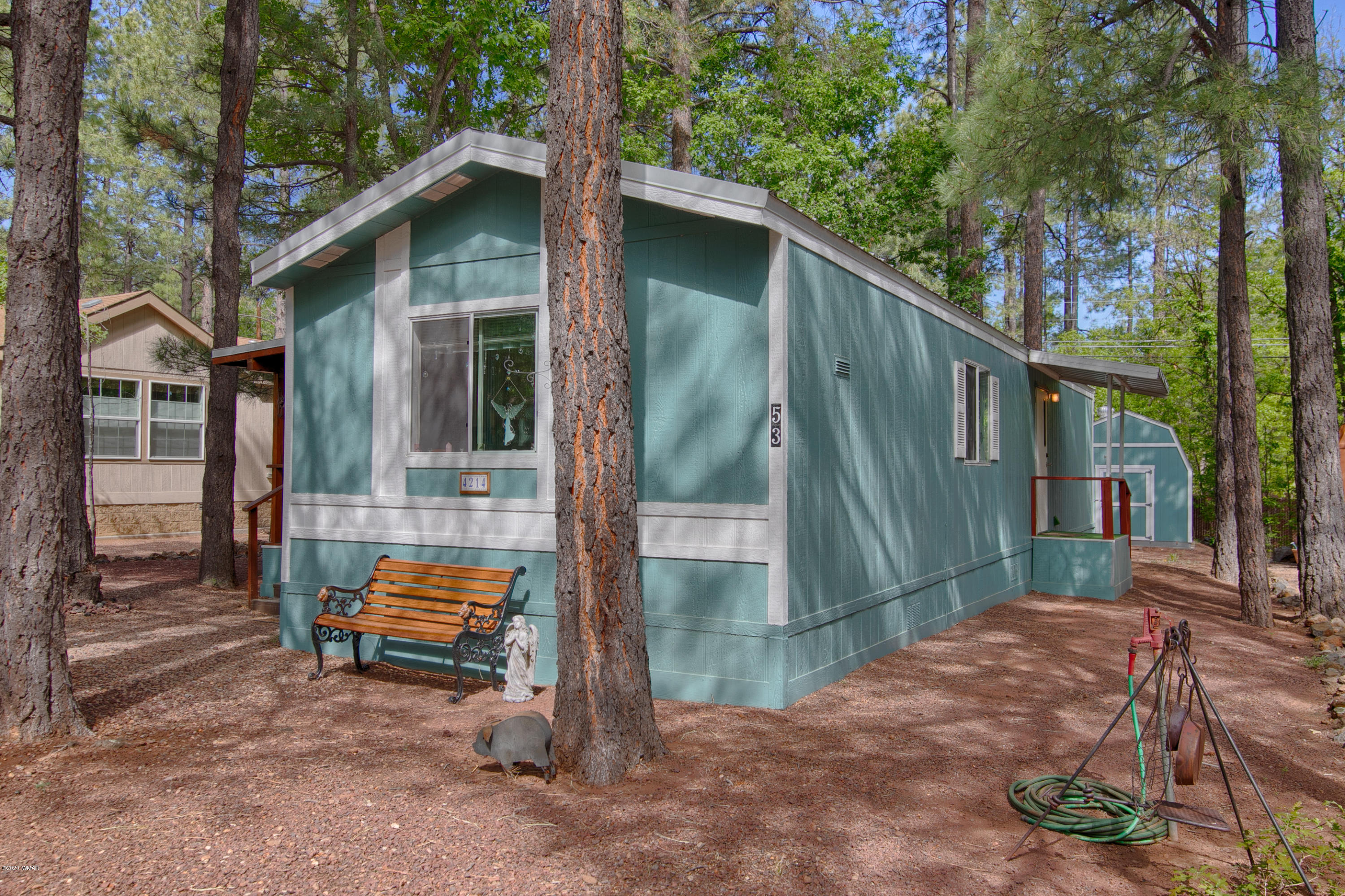 4214 West Blue Ridge Loop Pinetop, AZ 85935 - Photo 18 of 18 a backyard of a house with barbeque oven and table