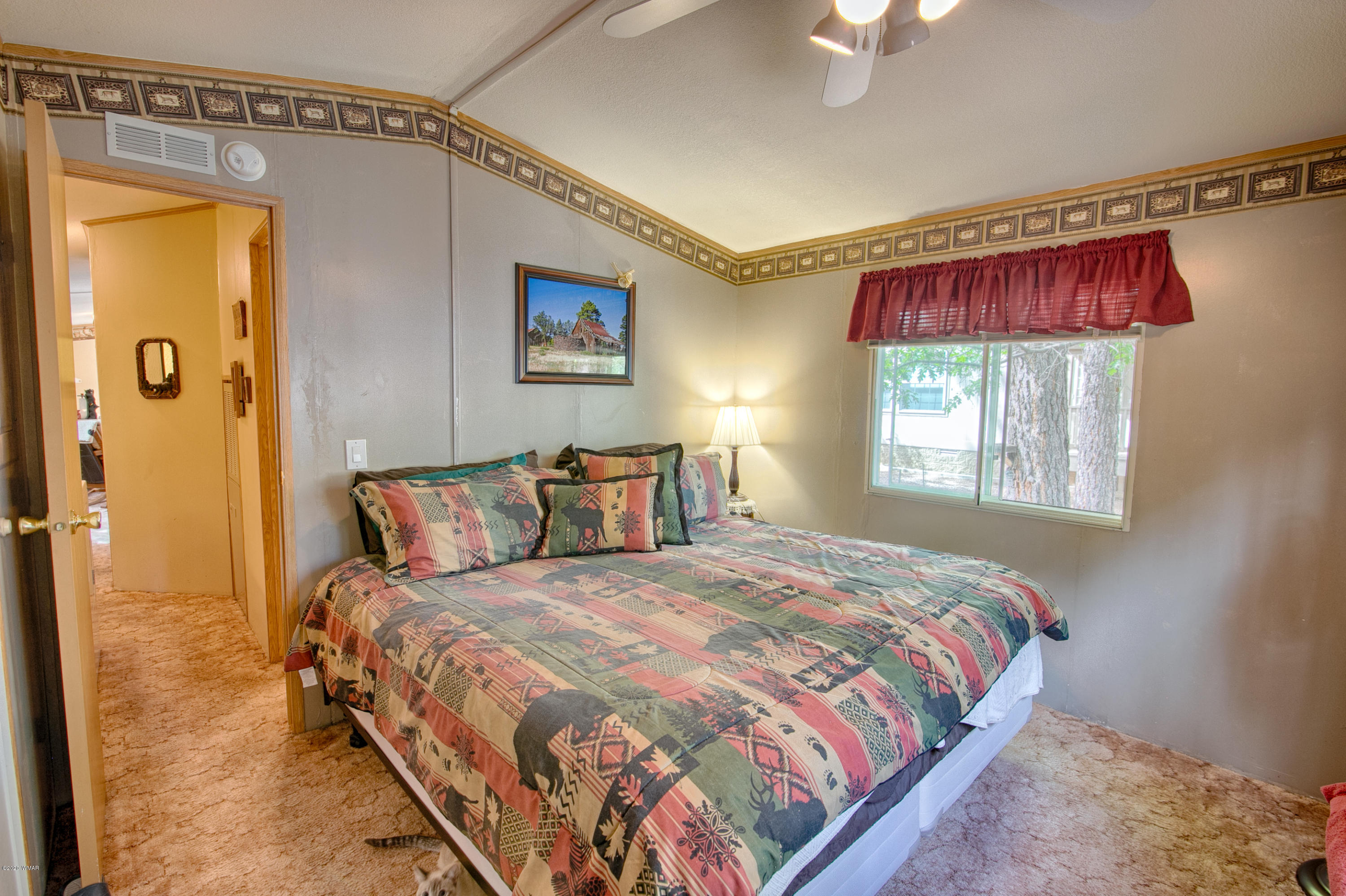 4214 West Blue Ridge Loop Pinetop, AZ 85935 - Photo 6 of 18 a bedroom with a bed and a window