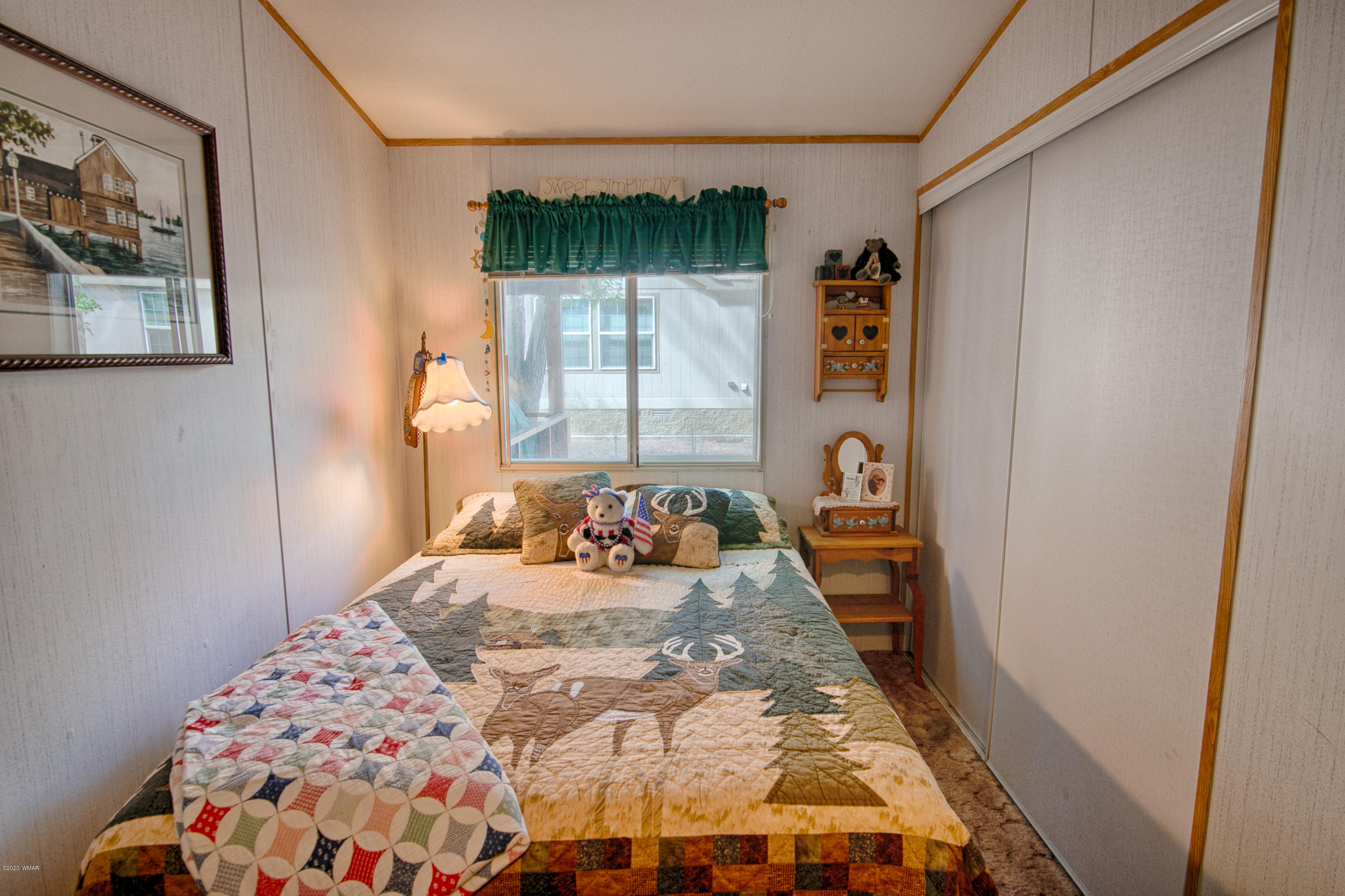 4214 West Blue Ridge Loop Pinetop, AZ 85935 - Photo 8 of 18 a bedroom with a bed and a window