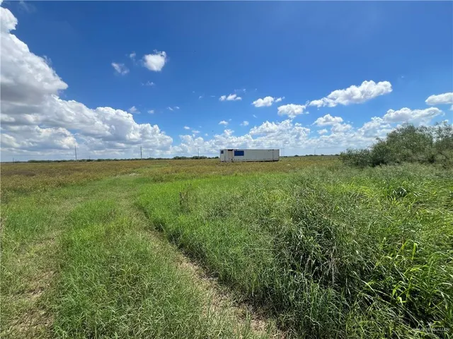 a view of a big yard with swimming pool and outdoor seating