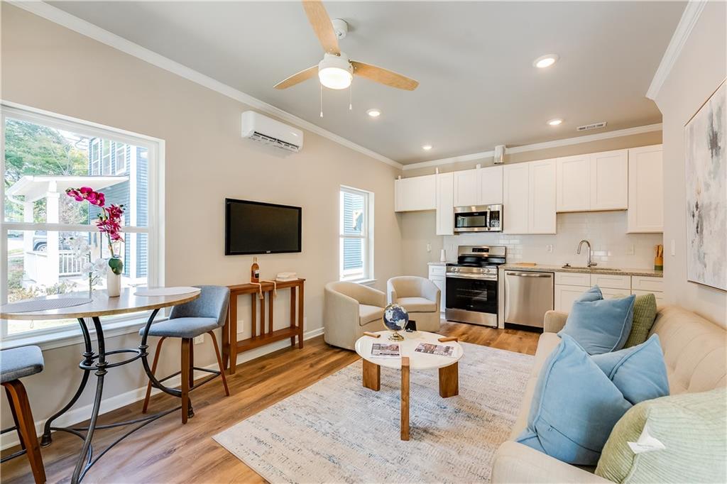 971 Peeples Street Southwest Atlanta, GA 30310 - Photo 1 of 16 a living room with furniture kitchen view and a flat screen tv