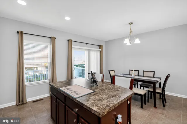 a view of a dining room with furniture and window