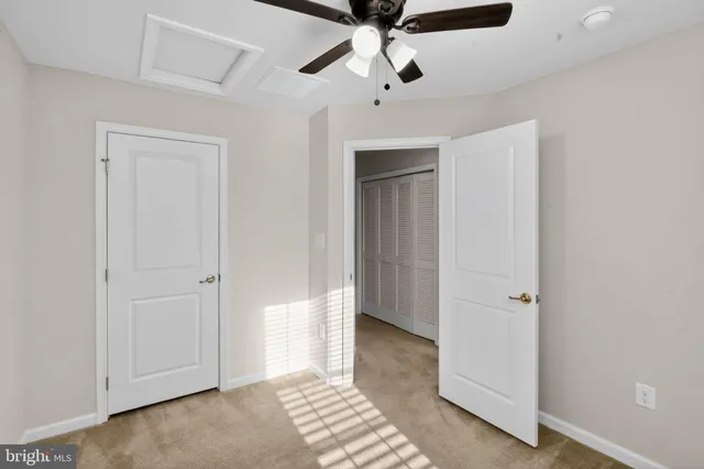 a view of a hallway with a livingroom and a bathroom with a sink