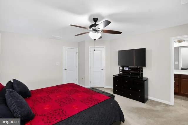 a bedroom with a large bed and a tv