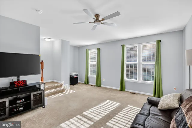 a bedroom with furniture and a flat screen tv