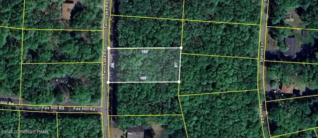 a view of a fence and trees and deck in the background