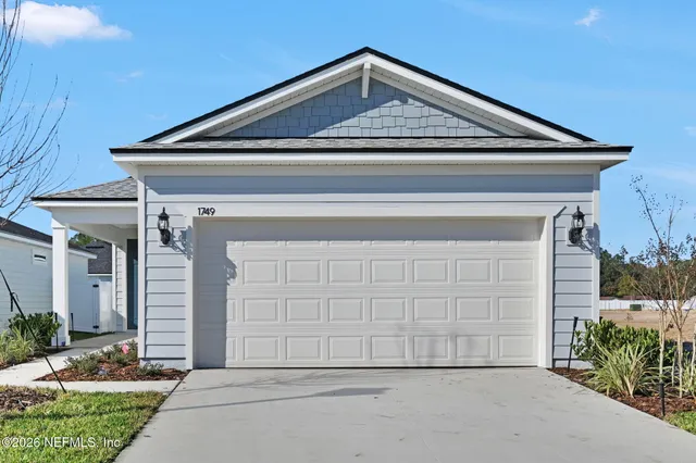 a front view of a house with garage