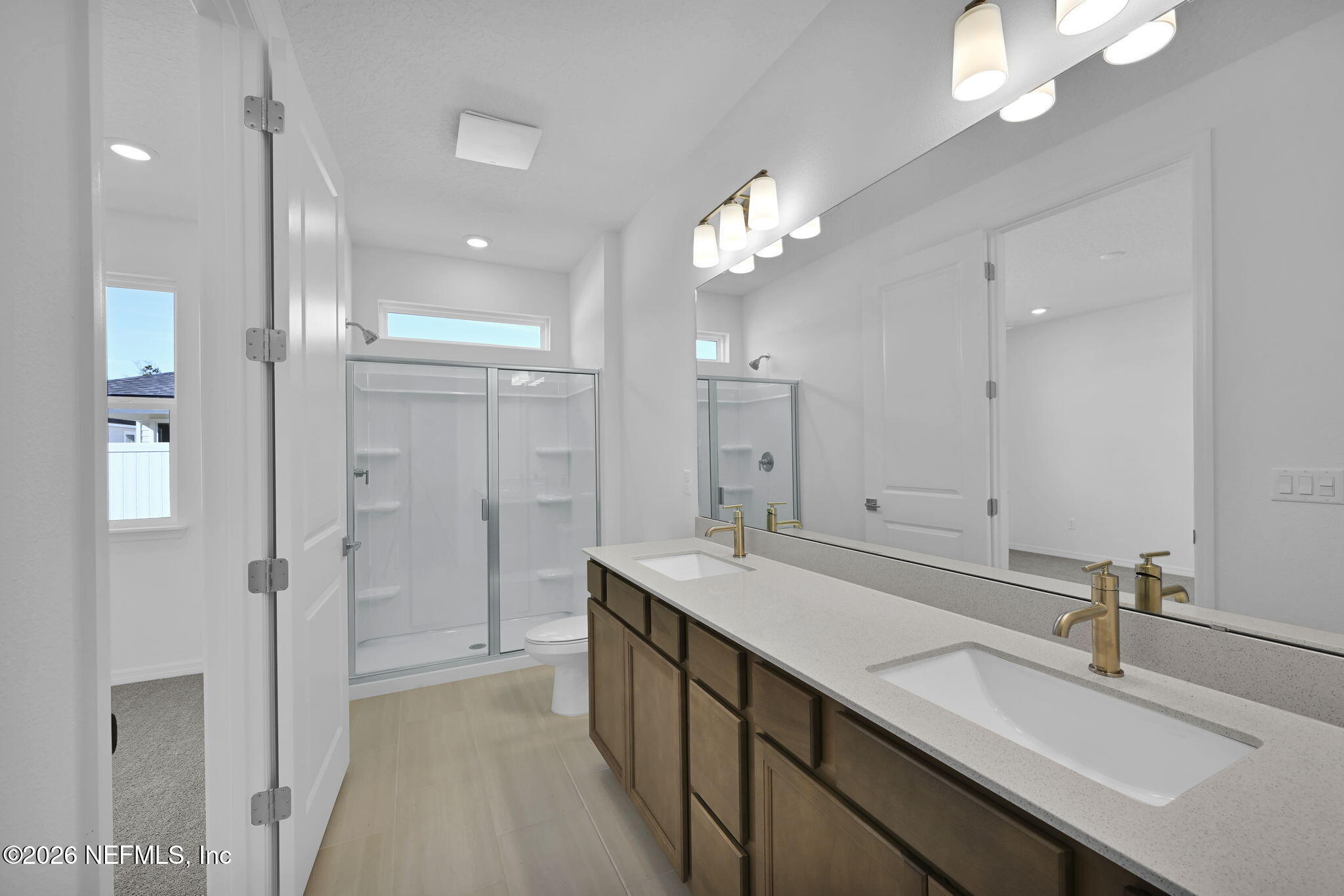 1749 Mickey Way Middleburg, FL 32068 - Photo 19 of 25 a bathroom with a double vanity sink mirror and shower