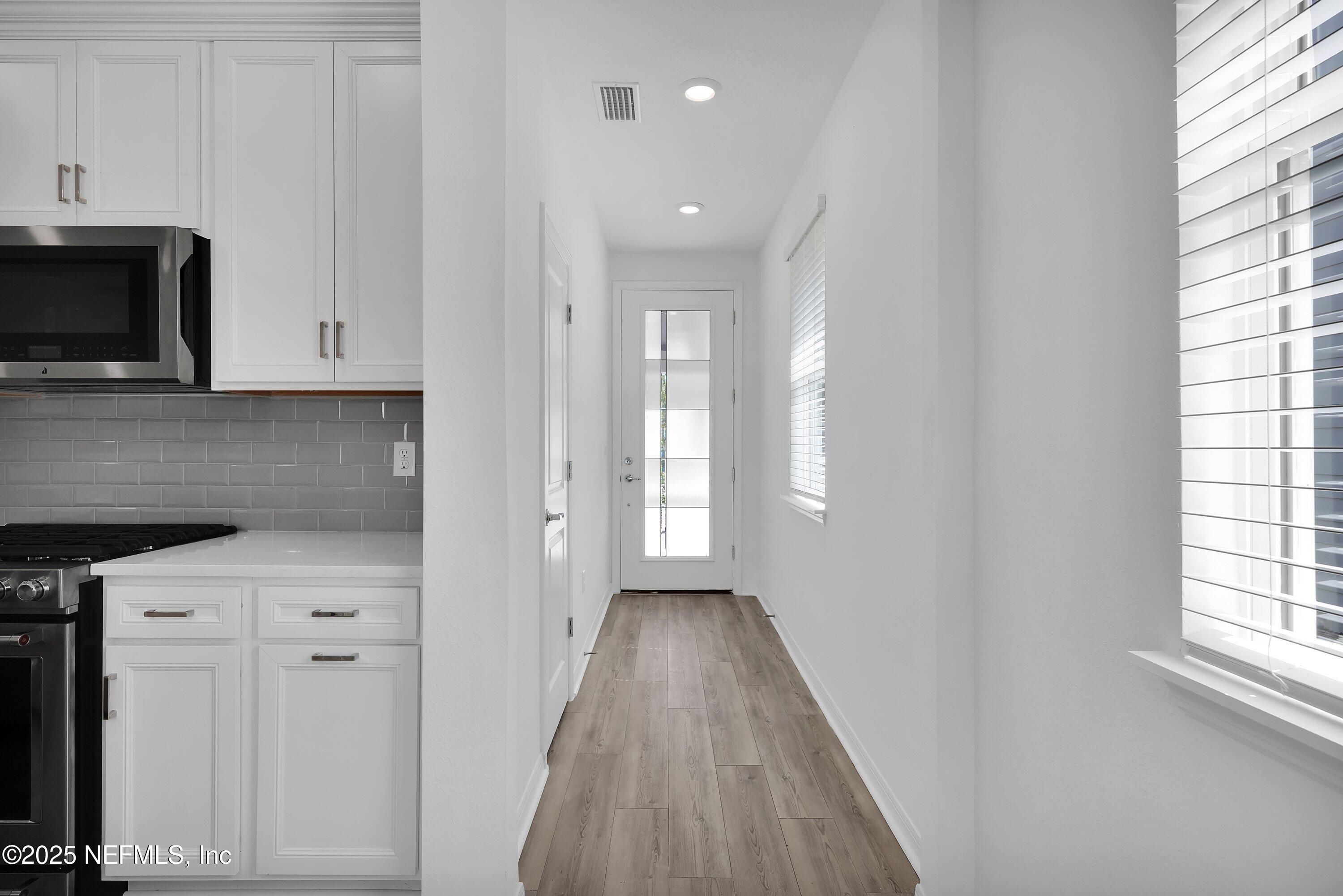 1749 Mickey Way Middleburg, FL 32068 - Photo 3 of 23 a view of hallway with window and wooden floor