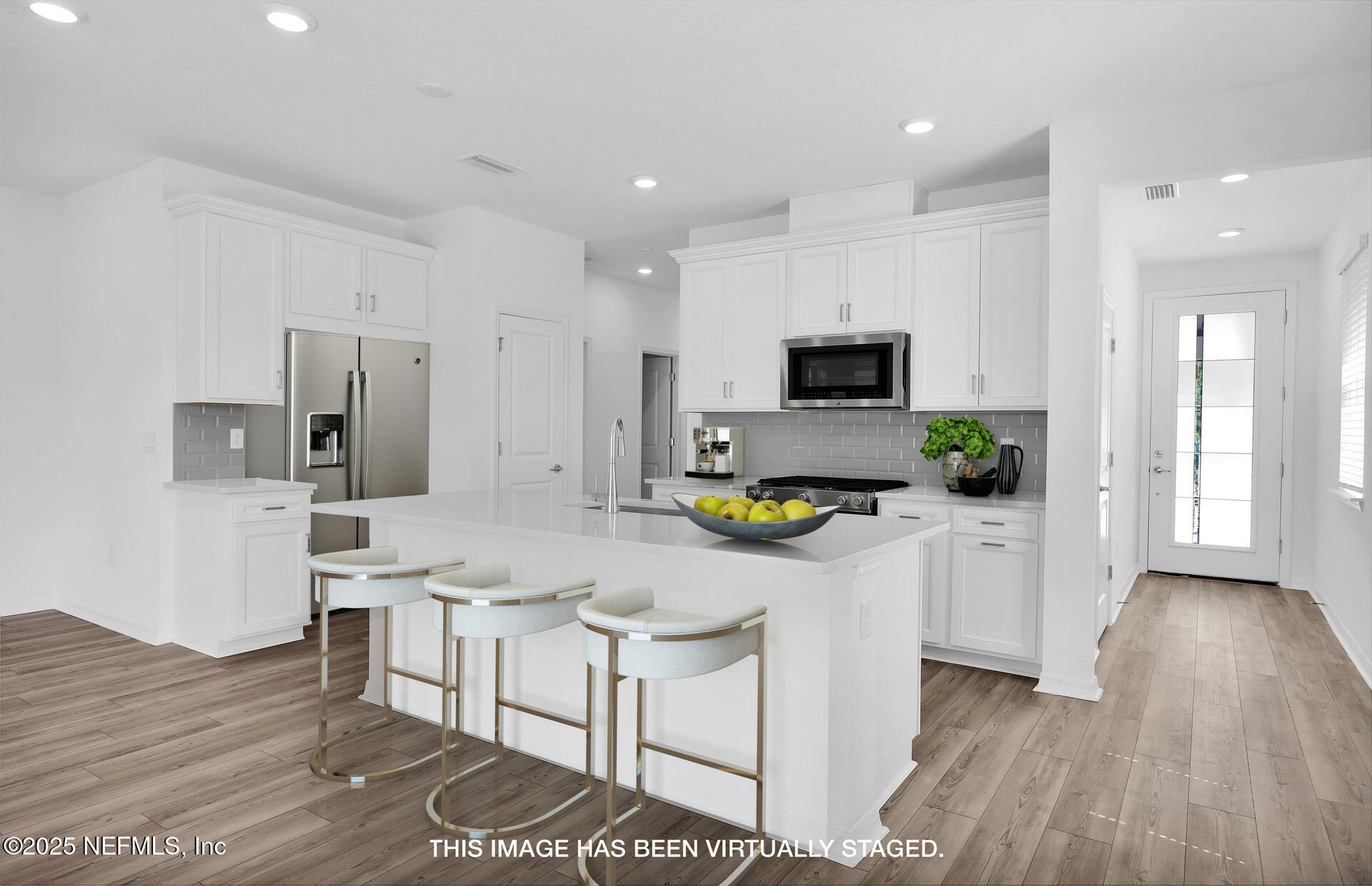 1749 Mickey Way Middleburg, FL 32068 - Photo 4 of 23 a kitchen with white cabinets and stainless steel appliances