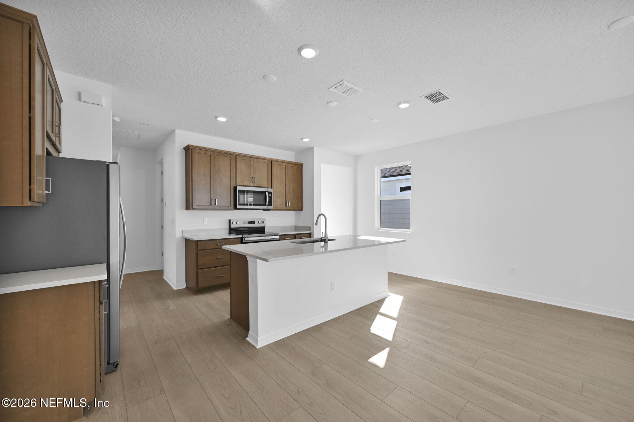 1749 Mickey Way Middleburg, FL 32068 - Photo 7 of 25 a kitchen with a sink cabinets and wooden floor