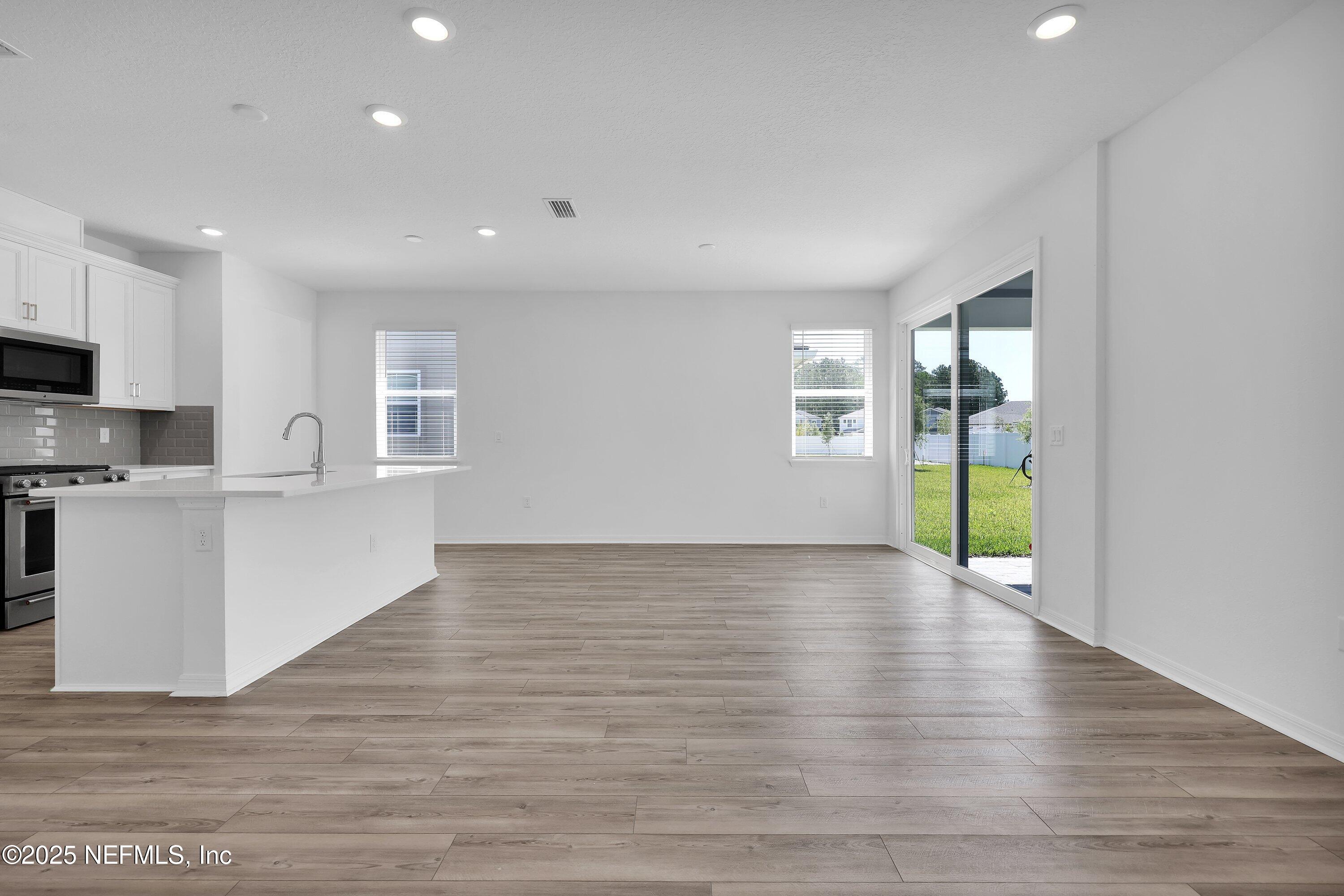 1749 Mickey Way Middleburg, FL 32068 - Photo 9 of 23 a view of an empty room with wooden floor and a window