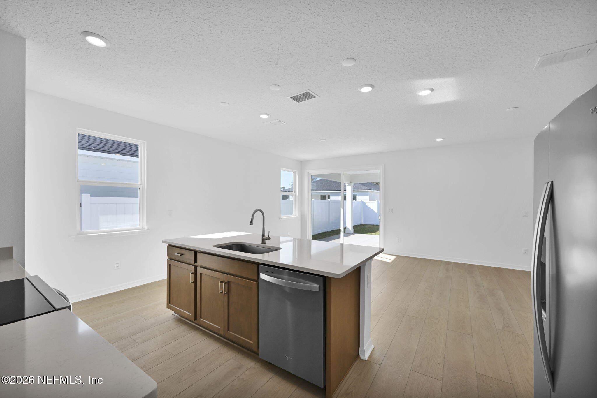 1749 Mickey Way Middleburg, FL 32068 - Photo 9 of 25 a kitchen with stainless steel appliances granite countertop a sink and a refrigerator