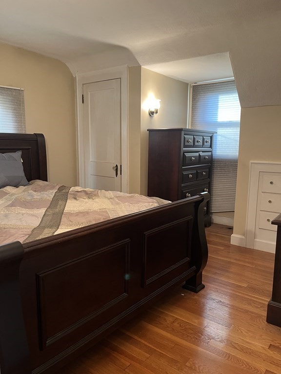 239 Plumtree Road Springfield, MA 01118 - Photo 12 of 14 a bedroom with a bed and wooden floor