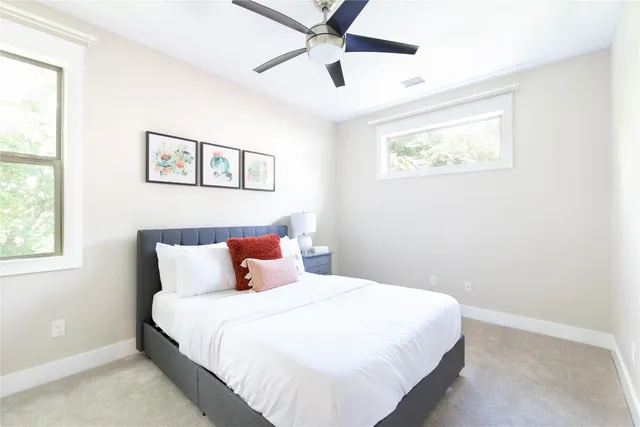 a bedroom with a large bed and a window