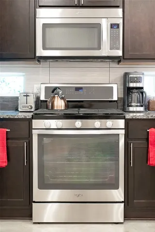 a stove top oven sitting inside of a kitchen