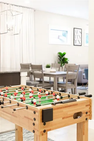 a room with stainless steel appliances kitchen island granite countertop a table and chairs in it