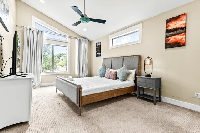 a bedroom with a bed next to a window with the outer view