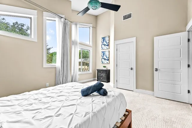 a bedroom with a large bed and a window