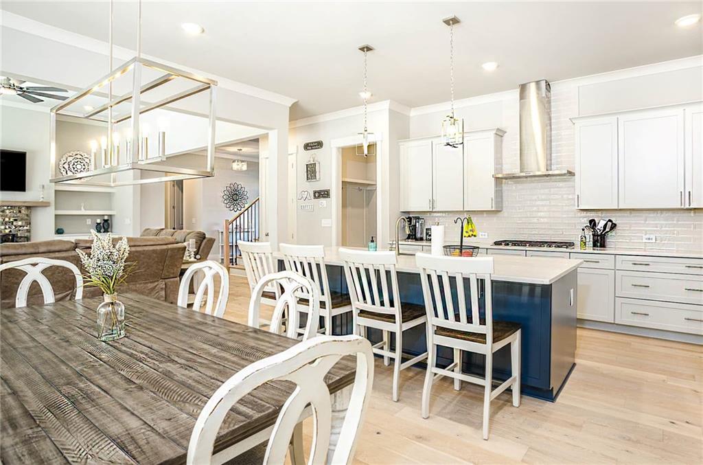 255 Old Town Road Dacula, GA 30019 - Photo 13 of 35 a kitchen with a dining table chairs and white cabinets