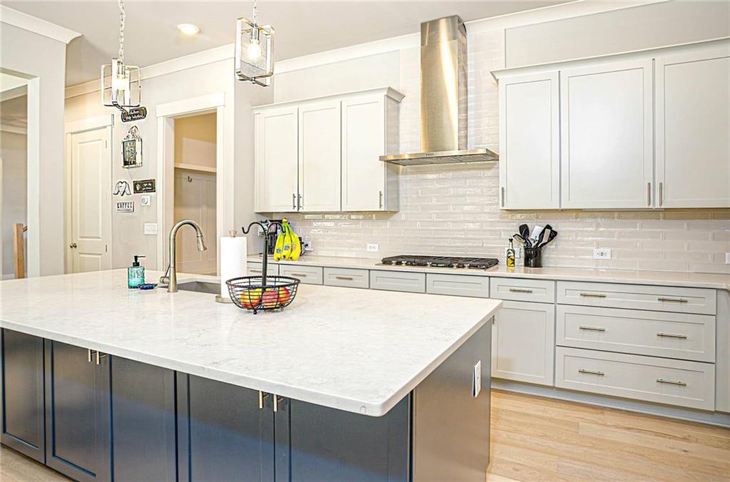 255 Old Town Road Dacula, GA 30019 - Photo 14 of 35 a kitchen with a sink a stove and white cabinets