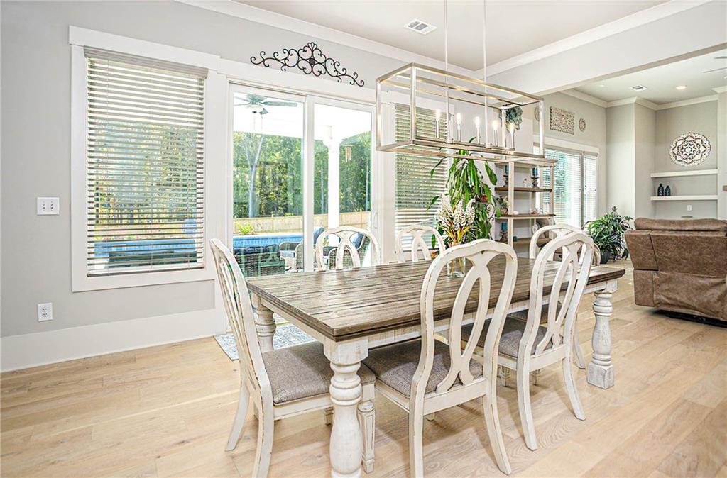 255 Old Town Road Dacula, GA 30019 - Photo 17 of 35 a dining room with furniture a chandelier and wooden floor