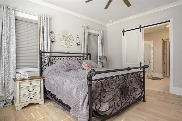 a bedroom with a bed and a window