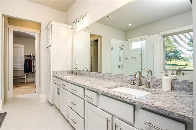 a bathroom with double sink and a mirror