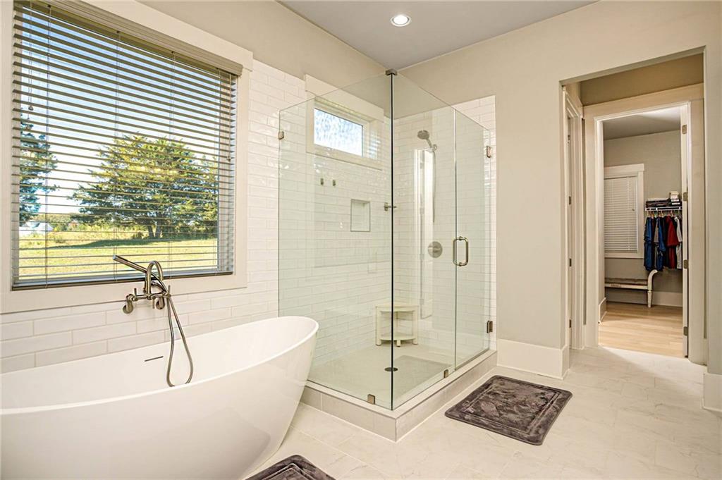 255 Old Town Road Dacula, GA 30019 - Photo 21 of 35 a bathroom with a tub a sink a mirror and a shower