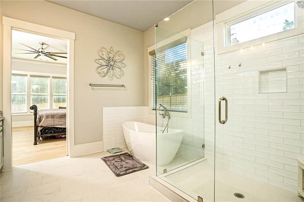 255 Old Town Road Dacula, GA 30019 - Photo 22 of 35 a bathroom with a tub shower and window