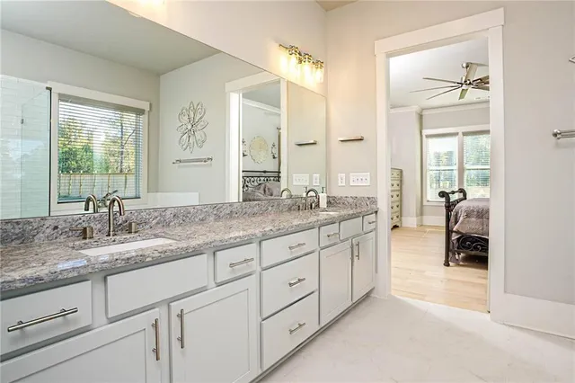 a bathroom with double vanity and a mirror