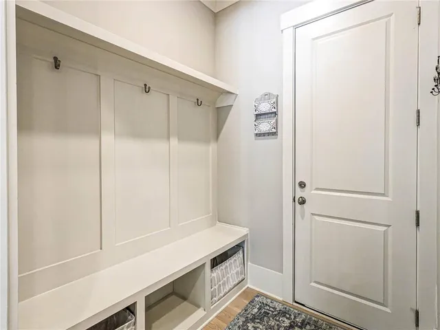 a room with a shower and cabinets