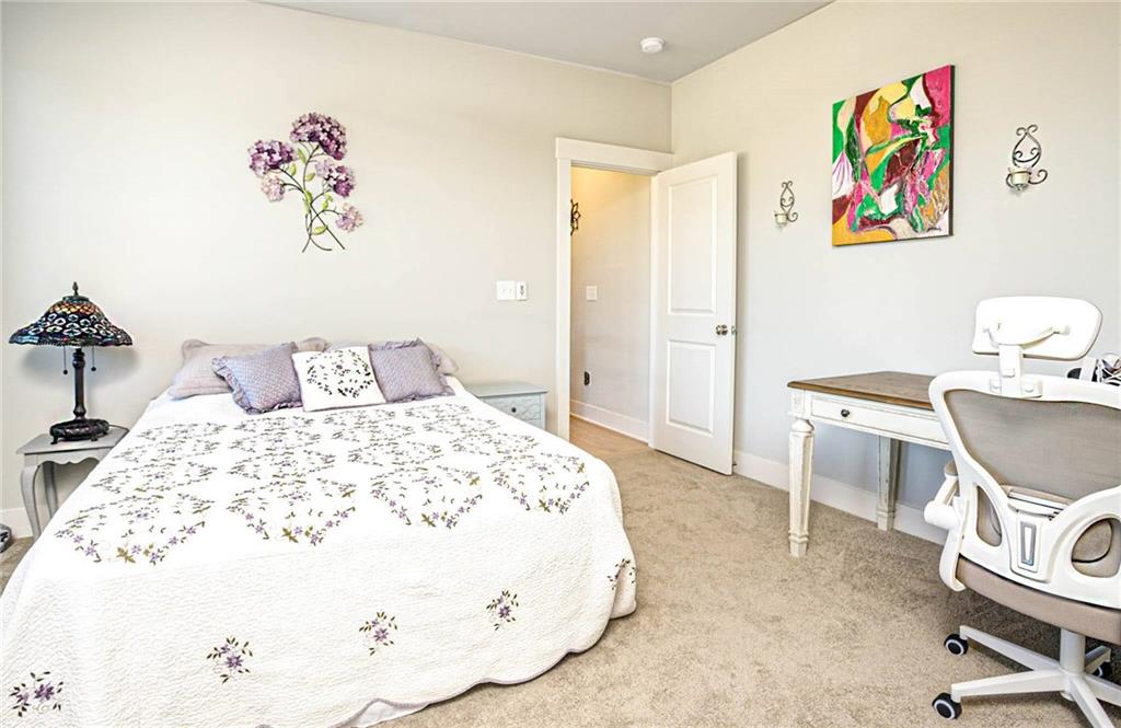 255 Old Town Road Dacula, GA 30019 - Photo 28 of 35 a bedroom with a bed and painting on the wall