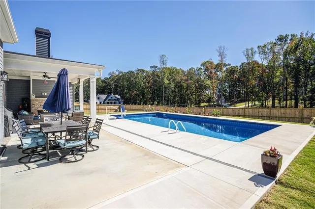 a view of a swimming pool with chairs