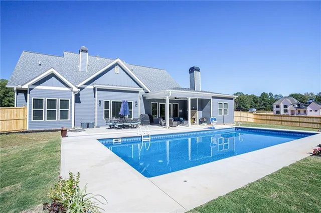 a view of a house with swimming pool and front view of a house