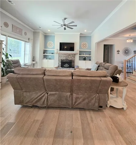 a living room with furniture a fireplace and a flat screen tv